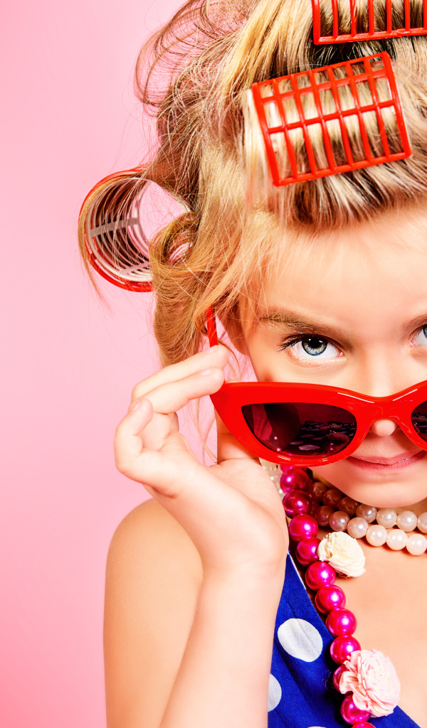 Гламурная девочка в больших красных очках и бигудями на голове