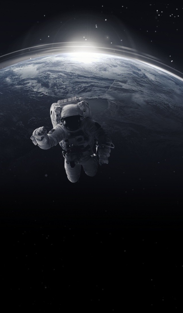 Астронавт в открытом космосе на фоне планеты земля 