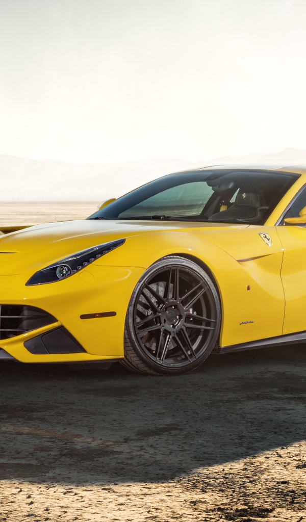 Спортивный автомобиль Ferrari F12 на песчаной дороге