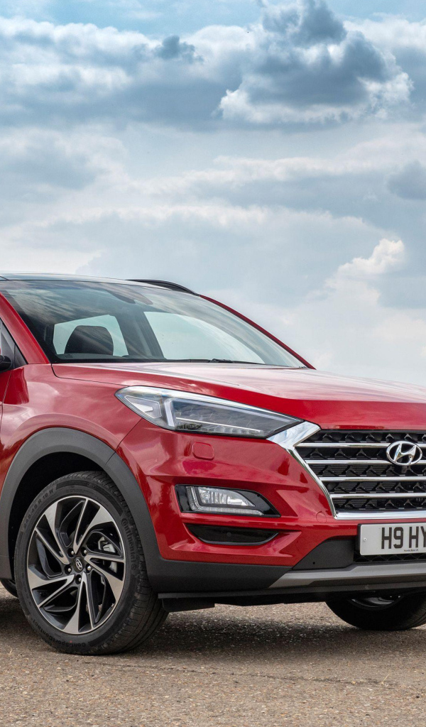 Красный автомобиль Hyundai Tucson, 2019 года под пасмурным небом