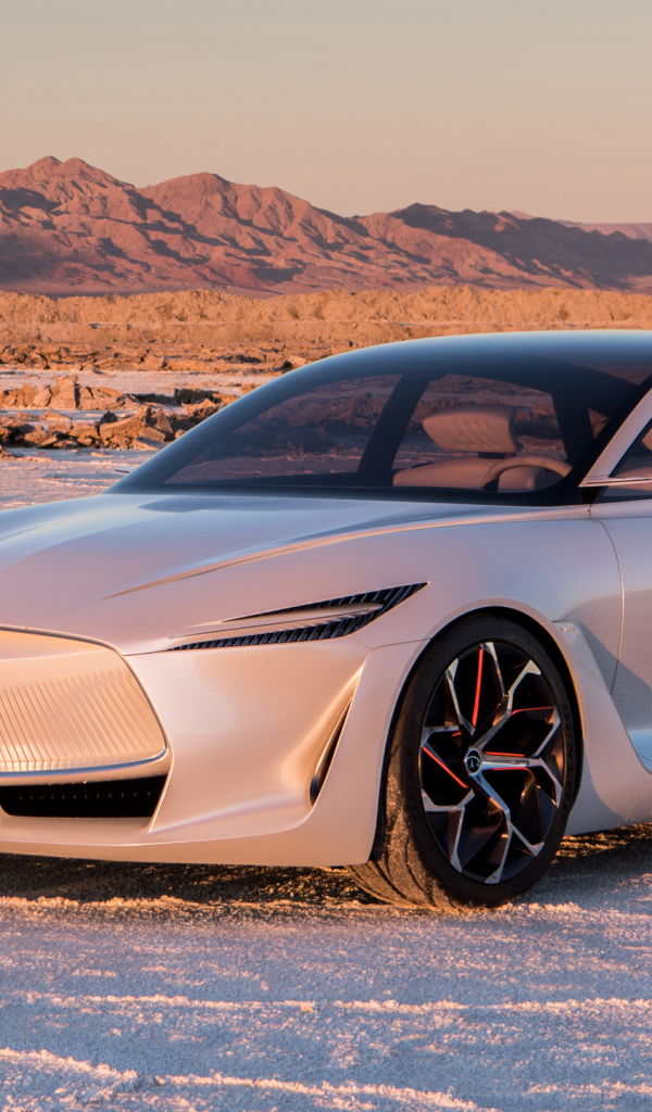 Silver car Infiniti Q Inspiration Concept, 2018 stands on the snow in the background of the mountains