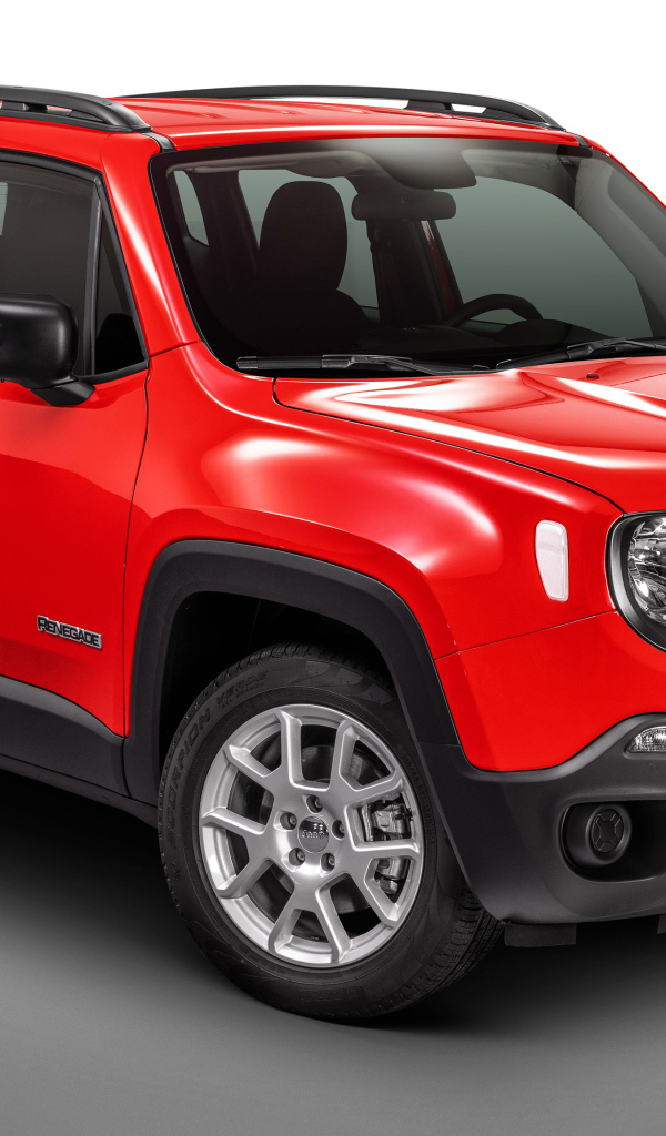 Красный автомобиль Jeep Renegade Sport на сером фоне