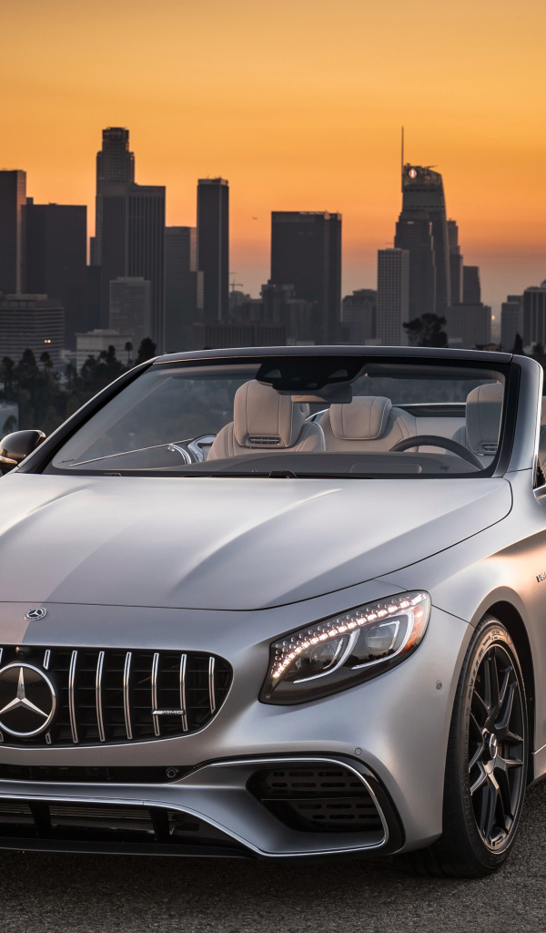 Silver car Mercedes AMG S63 4MATIC Cabriolet, 2018 on the background of a metropolis