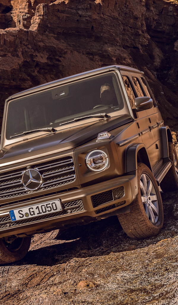 The big expensive car is Mercedes Benz G 500, 2018 in the mountains
