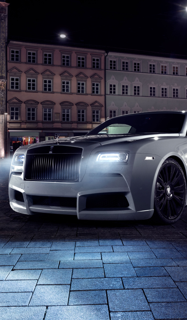 Expensive car Rolls Royce Wraith with headlights on