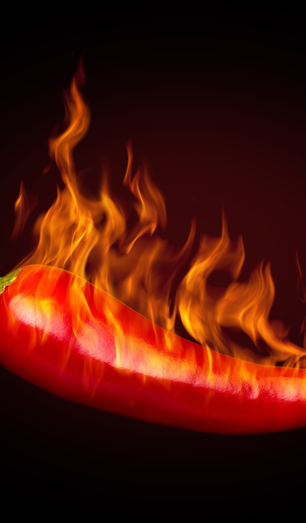 Красный перец с пламенем на черном фоне