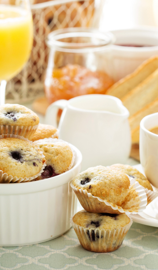 Чашка кофе с кексами на столе 