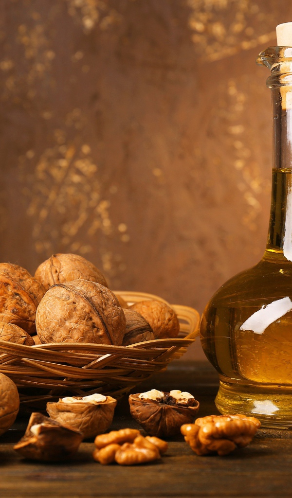 Butter in a glass bottle on a table with walnuts