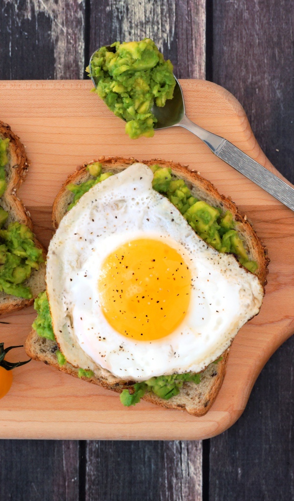 Бутерброды с яичницей на разделочной доске 