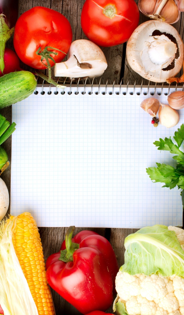 Notebook with fresh vegetables on the table