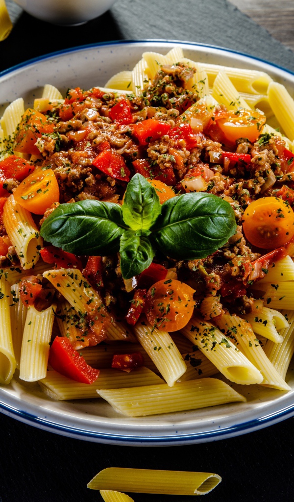 Pasta with minced meat and tomatoes on the table