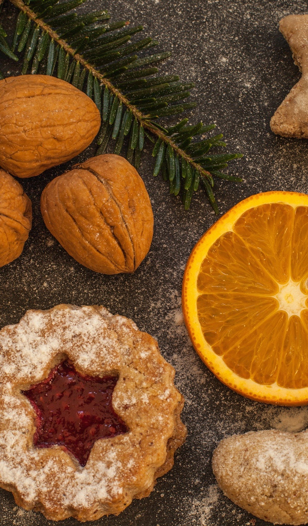 Печенье на столе с грецкими орехами и кусочком апельсина