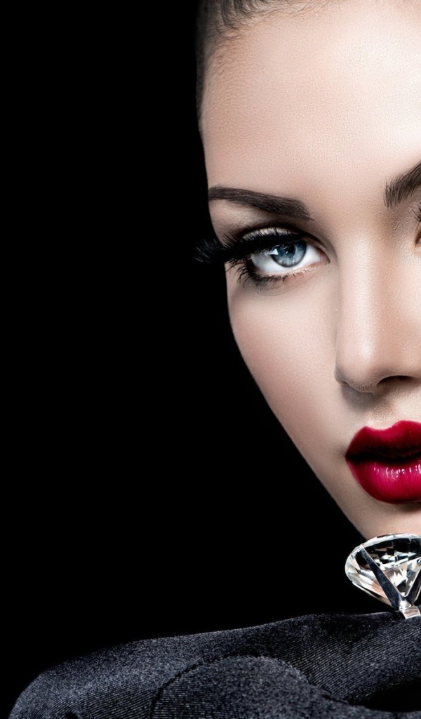 Красивая голубоглазая девушка с кольцом на пальце на черном фоне