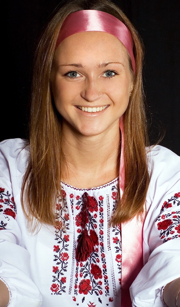 Красивая девушка в вышитой рубашке на черном фоне