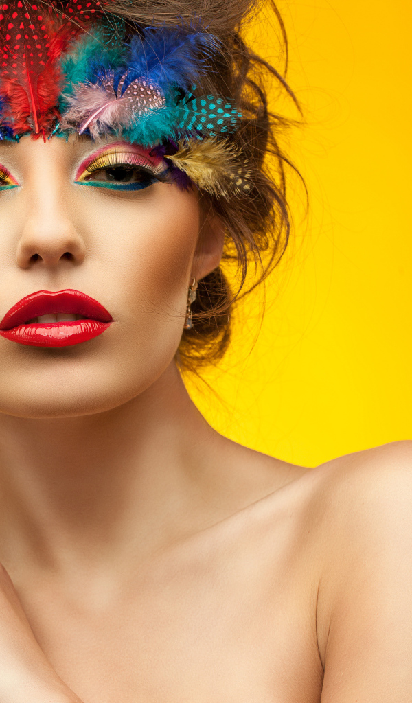 Красивая девушка с ярким макияжем на желтом фоне