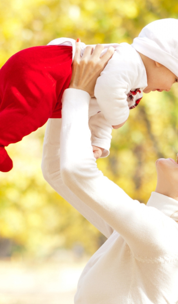 Счастливая девушка с младенцем на руках