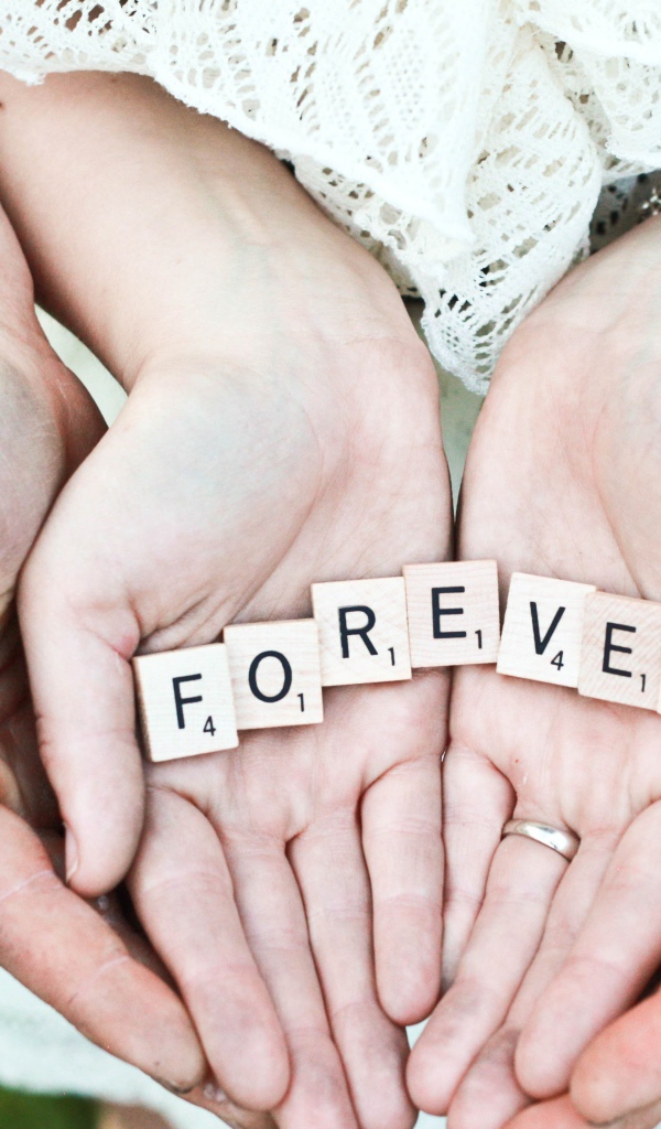 Руки влюбленной пары с надписью FOREVER