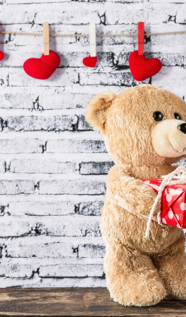 Влюбленные плюшевые мишки на фоне стены с сердечками 