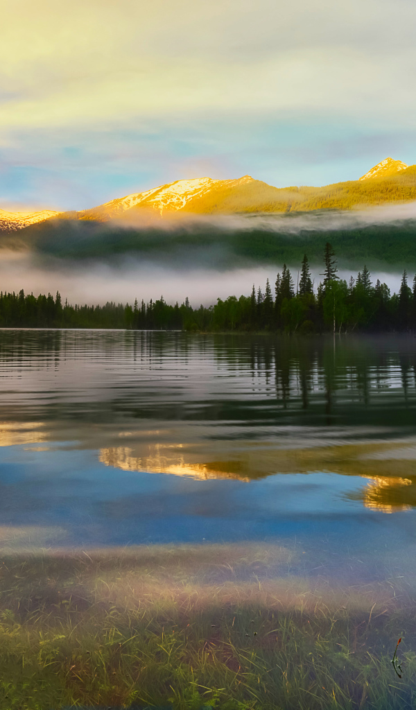 Morning mist over the water at sunrise in the mountains