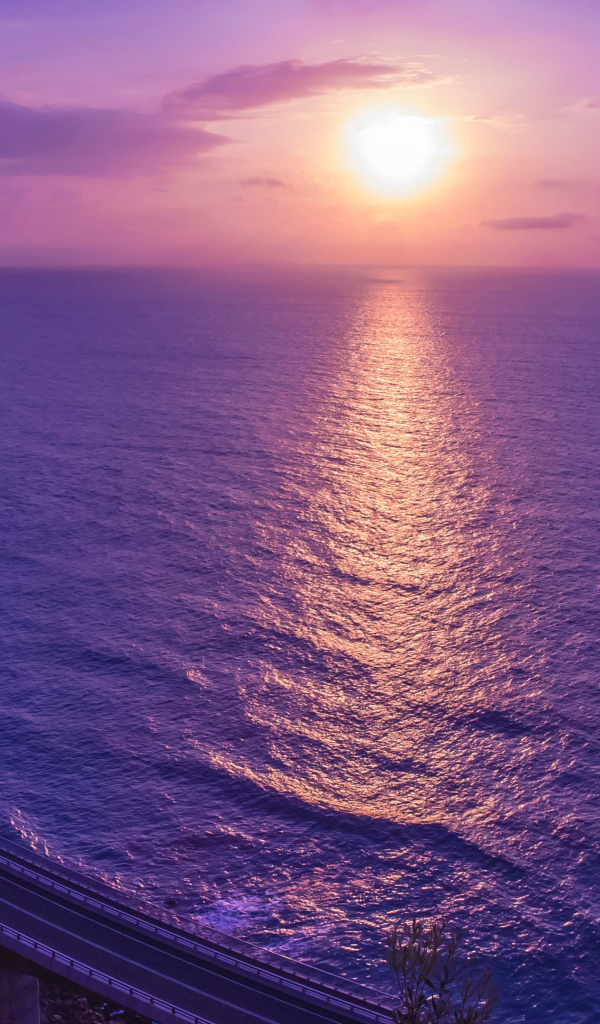 Фиолетовый закат солнца отражается в море 