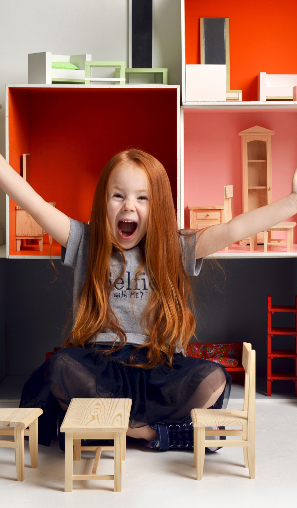 Маленькая девочка с игрушечной мебелью