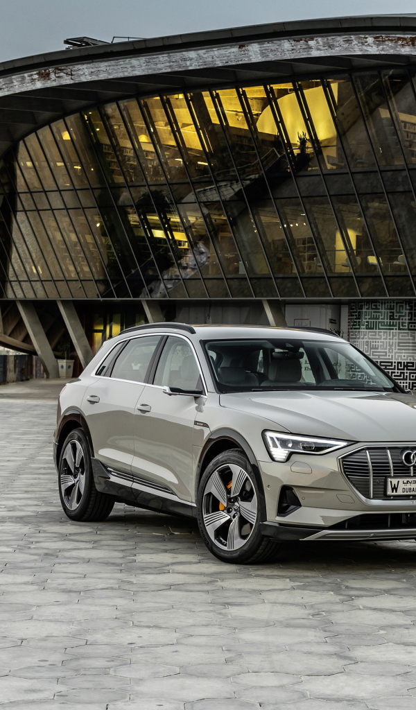 Silver car Audi E-Tron 55 Quattro 2019 on the background of the building