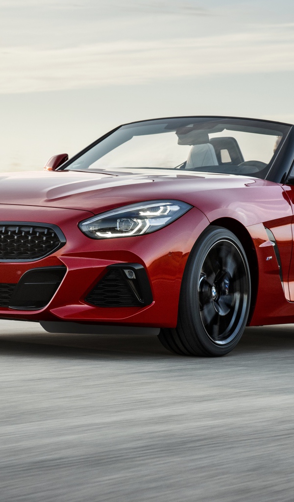 Красный автомобиль кабриолет BMW Z4 на дороге