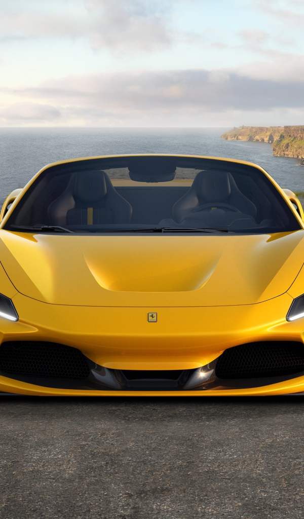 Желтый быстрый автомобиль Ferrari F8 Spider 2019 года у моря