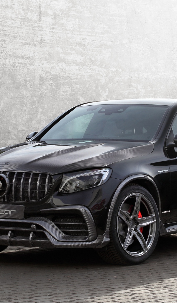 Black car Mercedes-AMG GLC 63 on the background of a gray wall
