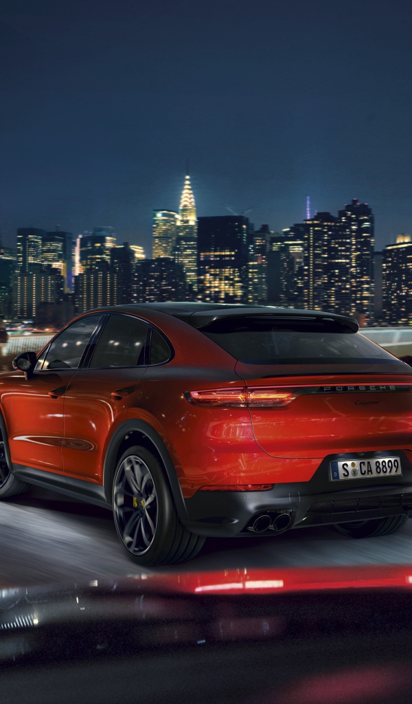 Красный внедорожник Porsche Cayenne Coupe 2019 года на фоне города