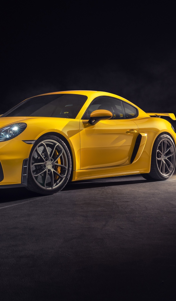 Yellow sports car Porsche 718 Cayman GT4, 2019 year on a gray background
