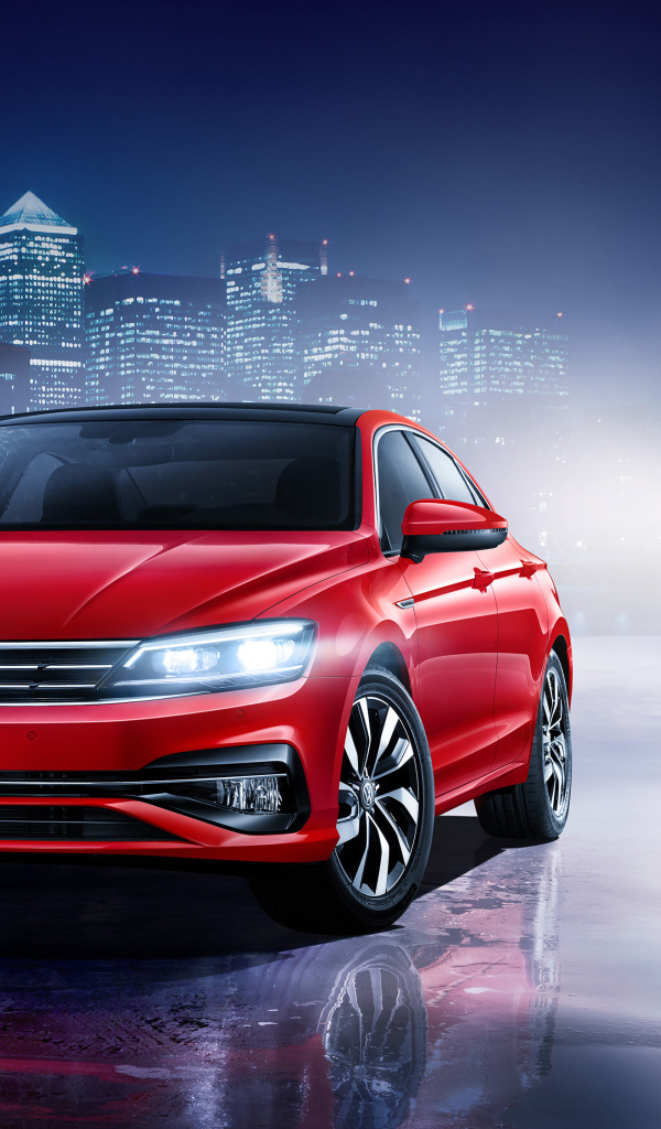 Красный автомобиль Volkswagen Lamando 2018 года на фоне ночного города 
