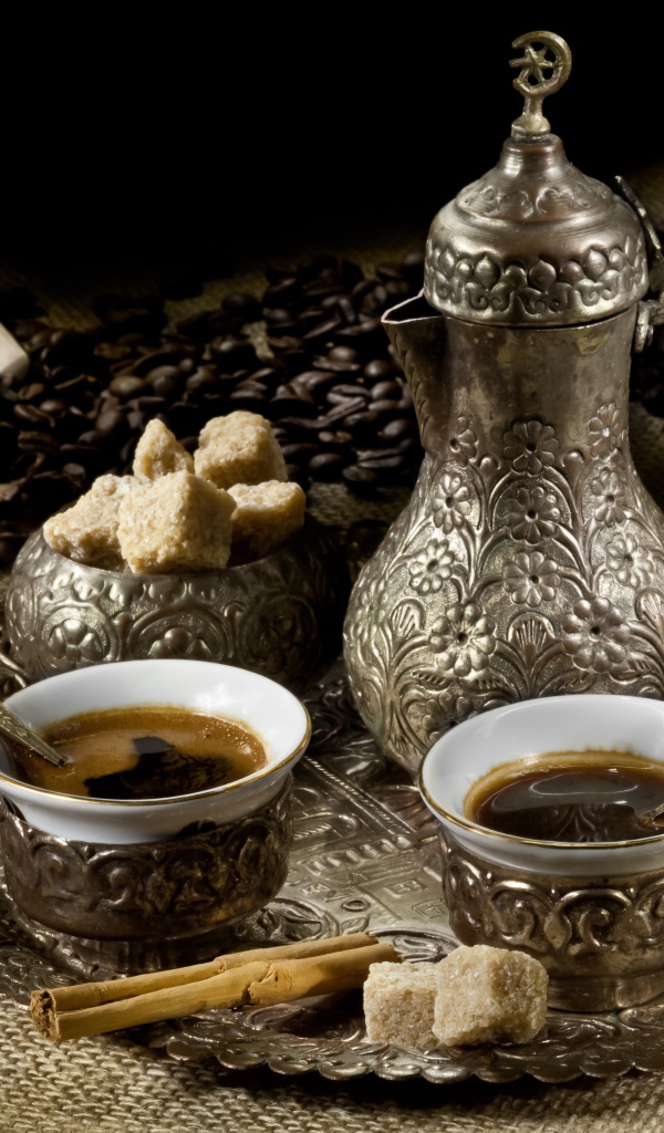 Чайный сервиз с кофе на столе с зернами