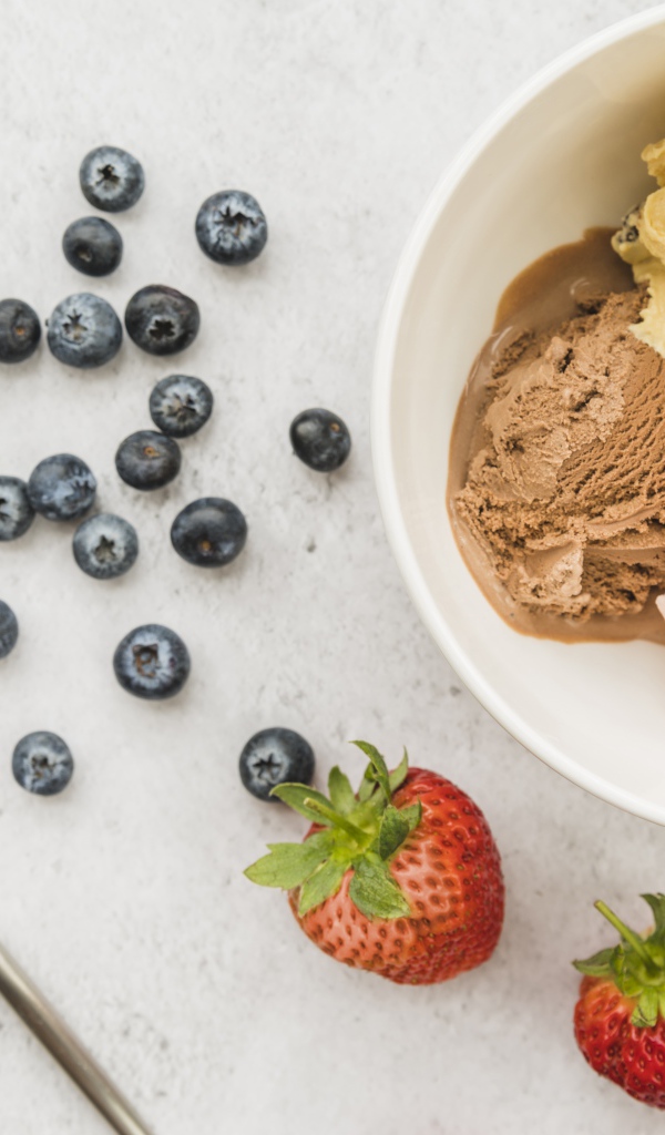 Мороженое на столе ягодами черники и клубники