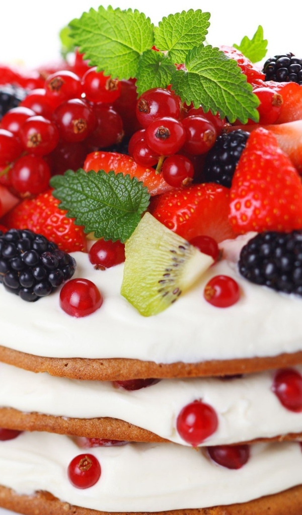 Панкейки с кремом и свежими ягодами на белом фоне