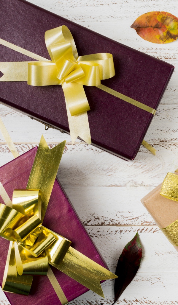 Три подарочные коробки с бантами на столе