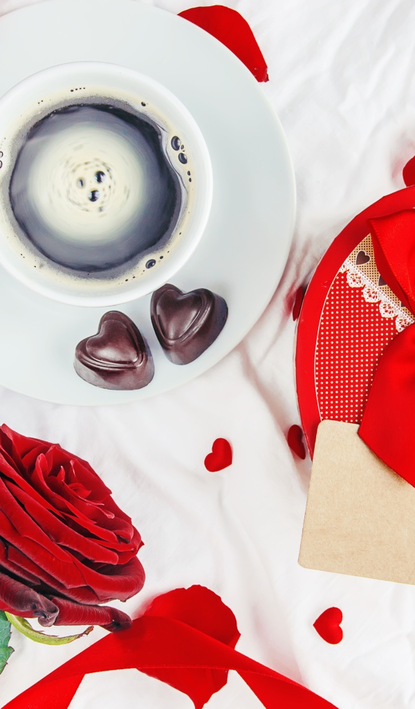 Чашка кофе на столе с коробкой в форме сердца и красной розой для любимой