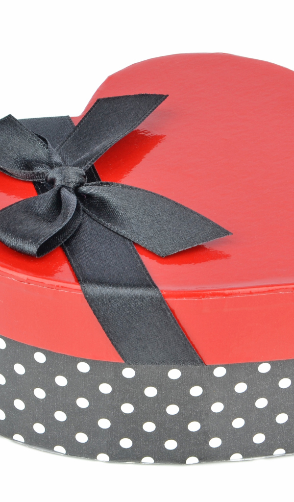 Красивая коробка в форме сердца с черным бантом на белом фоне