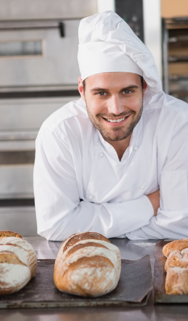 Handsome smiling male baker in uniform.