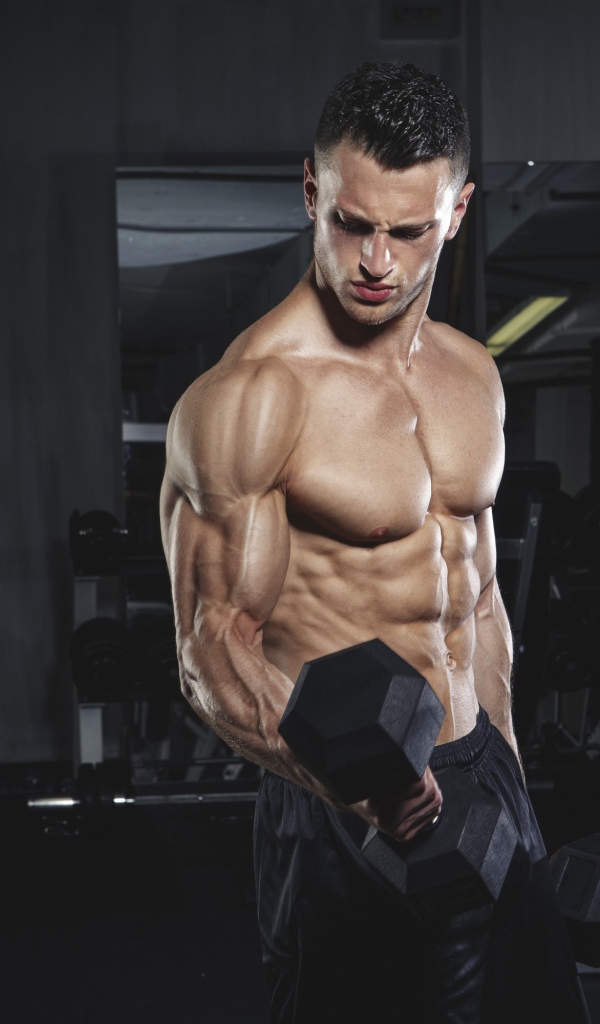 Inflated man with heavy dumbbells in his hands