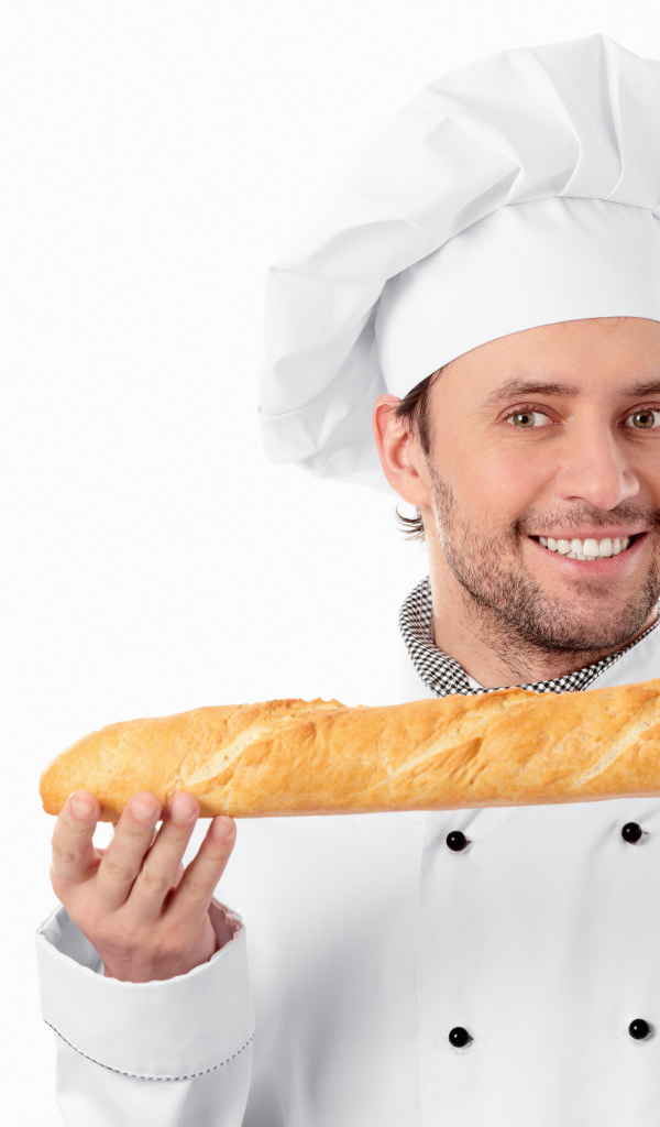 Male cook in a suit with a loaf in his hands