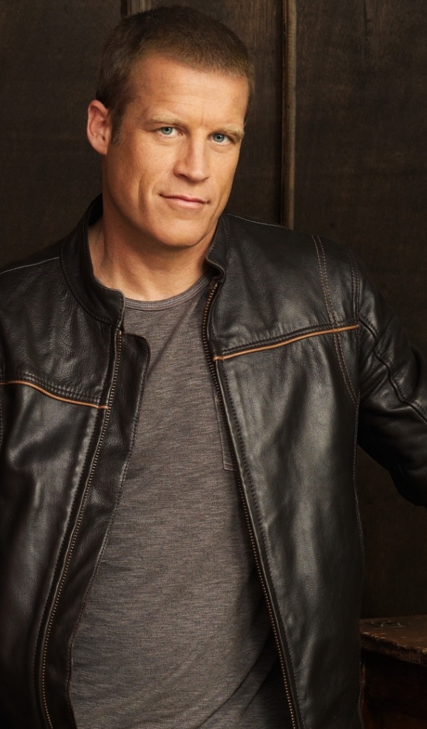 Красивый мужчина, актер Марк Вэлли в кожаной куртке