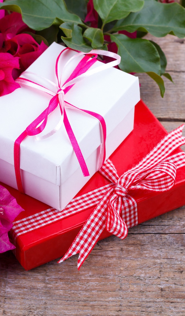 Две коробки с подарками на столе с цветами