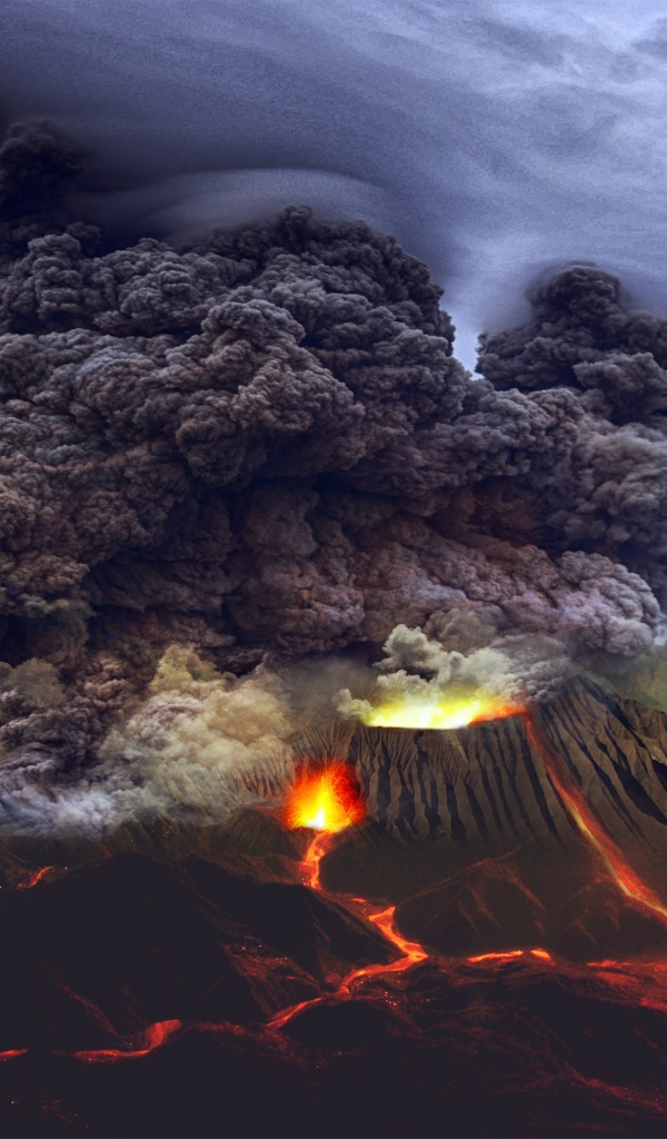 Густое облако черного дыма над извергающимся вулканом