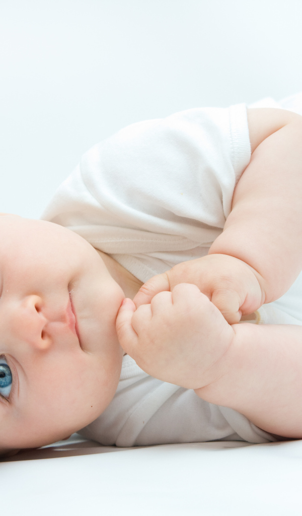 Забавный голубоглазый малыш на белом фоне