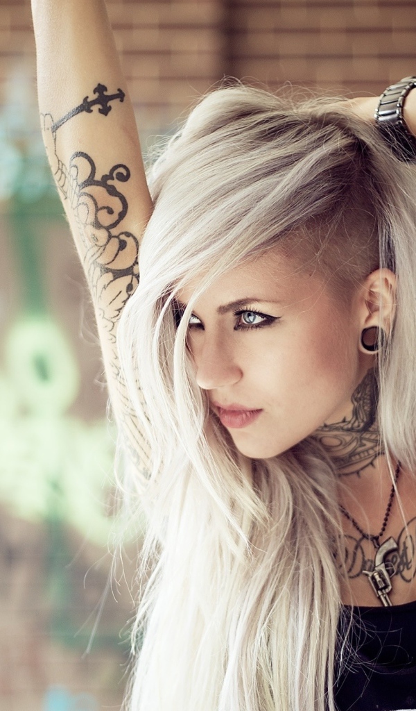 Красивая блондинка с татуировками на теле