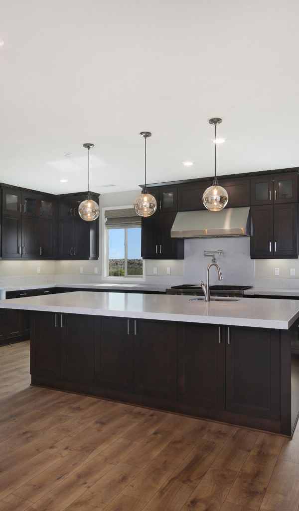 Large spacious kitchen with brown furniture.