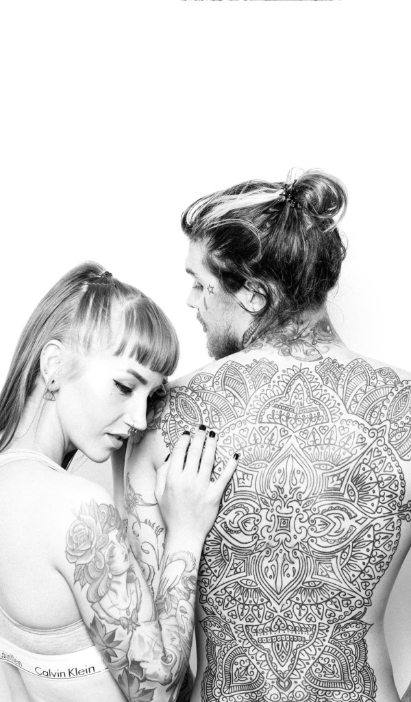 Man and girl with tattoos on the body on a white background