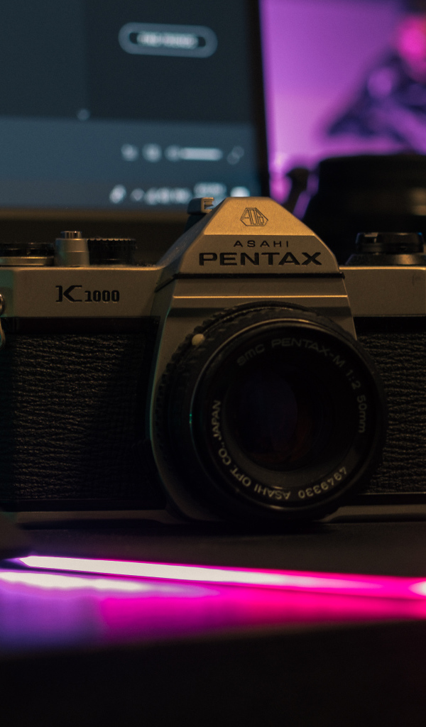 Фотоаппарат Pentax на столе с компьютером