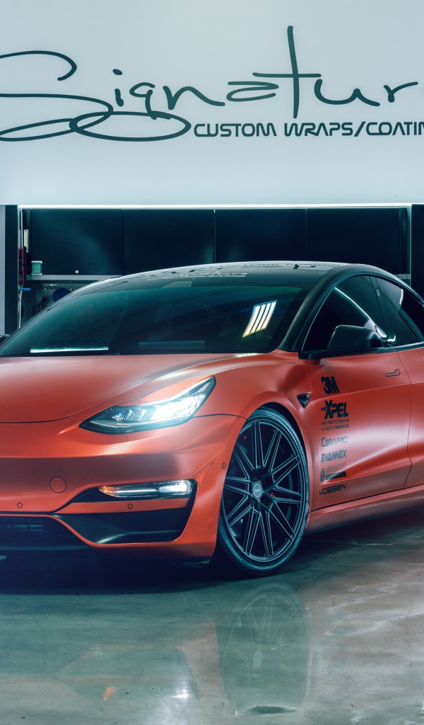 Красный автомобиль Tesla Model 3 в гараже